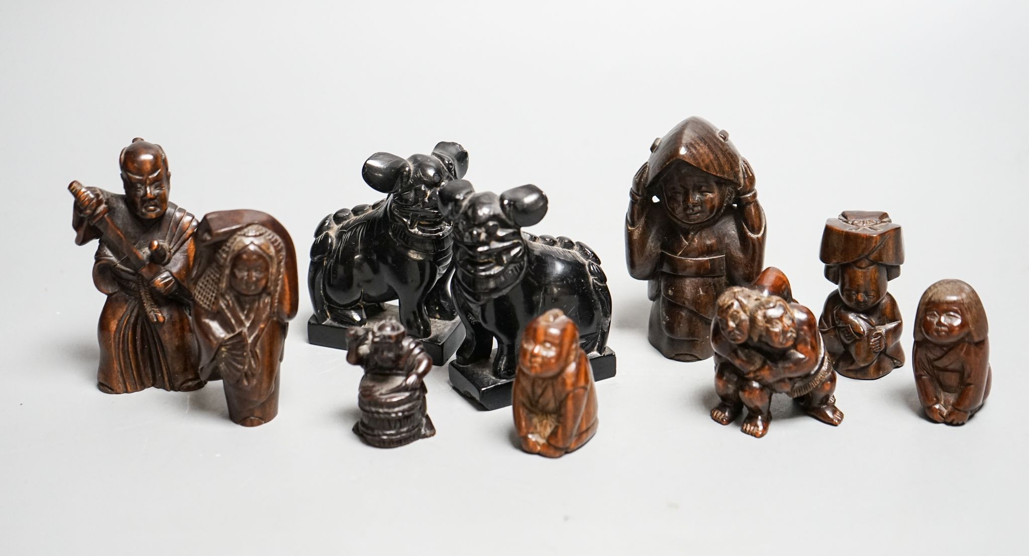 A quantity of hardwood netsuke and other carvings, signed